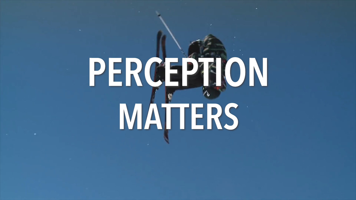 skier flying through sky with "Perception Matters" written across