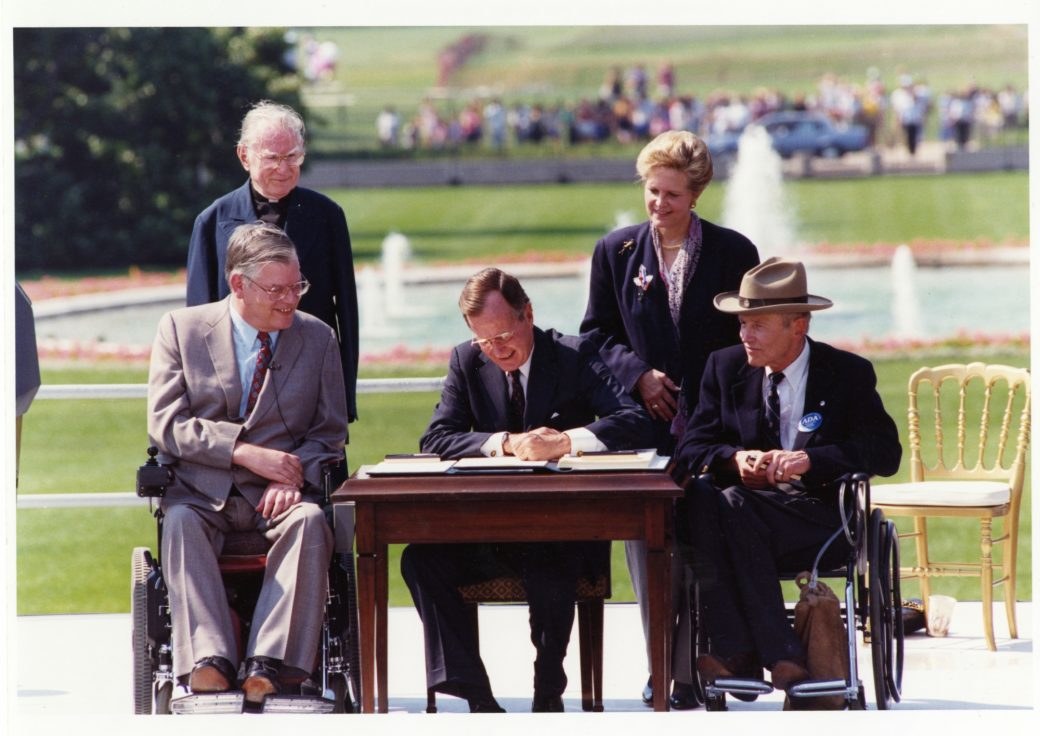 Signing of the ADA by George H.W. Bush with onlookers outside