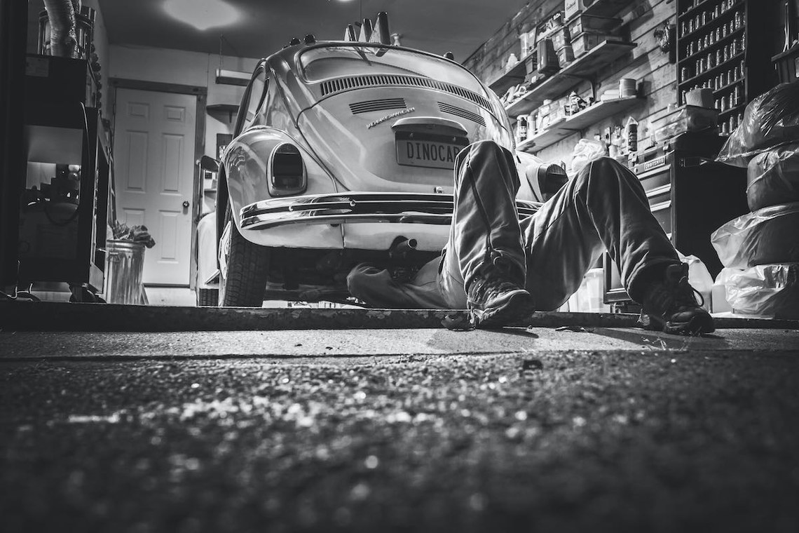 a mechanic under vw bug - metaphor for Wordpress auditing & remediation for WCAG compliance