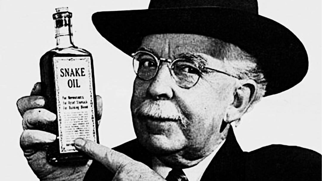 man in hat holding jar of snake oil