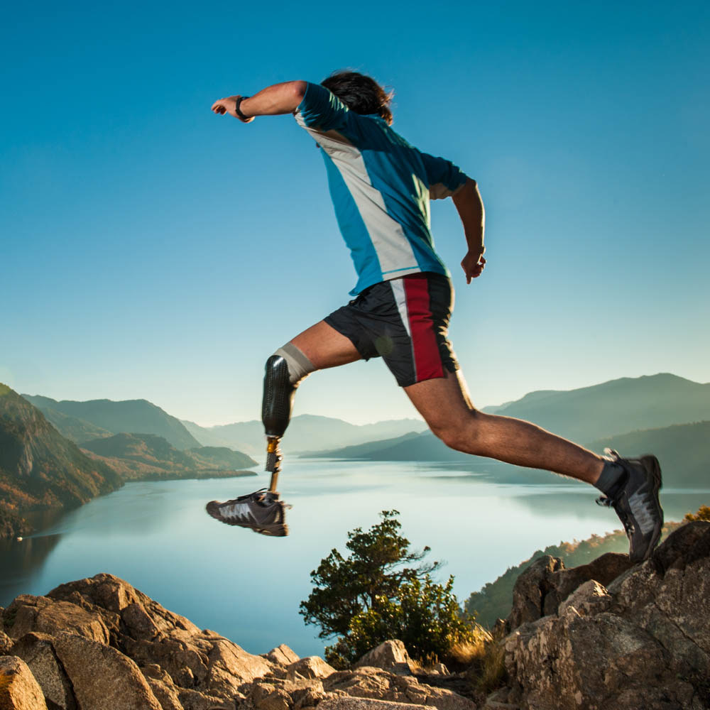 adaptive runner leaping with lake in background